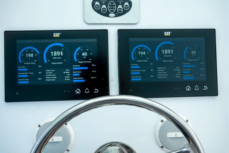 Slide: The Image of Digital dashboard of a 2007 Custom Carolina Layton Express boat, displaying engine metrics. - 13