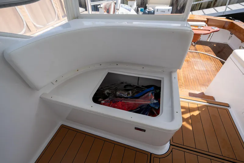 Slide: The Image of 2007 Custom Carolina Layton Express boat with open storage compartment on deck. - 19