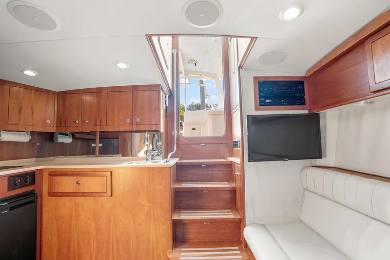 Slide: The Image of 2007 Custom Carolina Layton Express interior with wooden cabinetry, stairs, and modern amenities. - 20