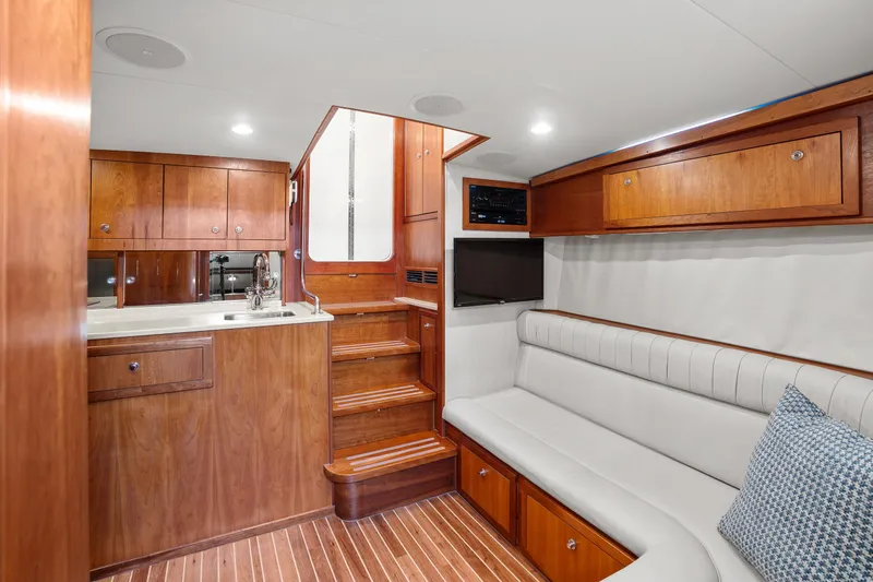 Slide: The Image of Luxurious 2007 Custom Carolina Layton Express yacht interior with wood cabinetry and white seating. - 21