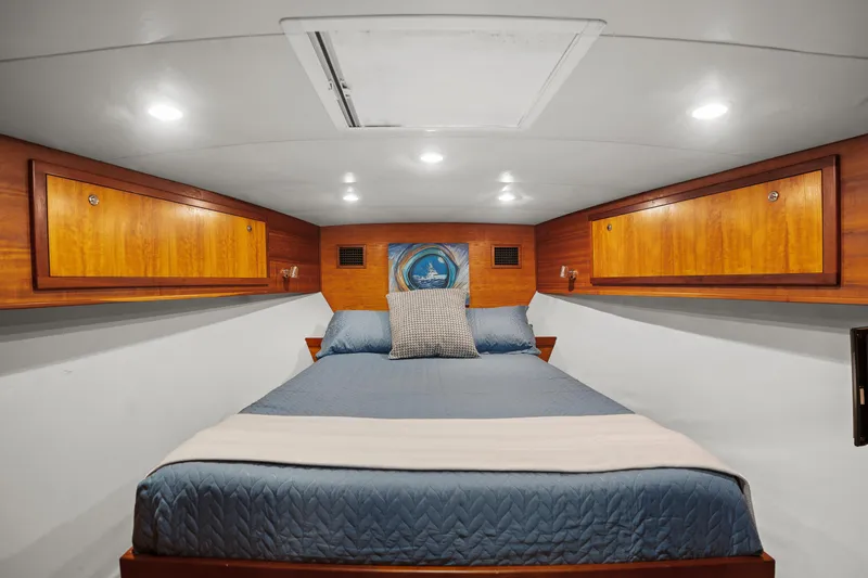 Slide: The Image of Luxurious cabin interior of 2007 Custom Carolina Layton Express with cozy bed and wooden cabinets. - 27