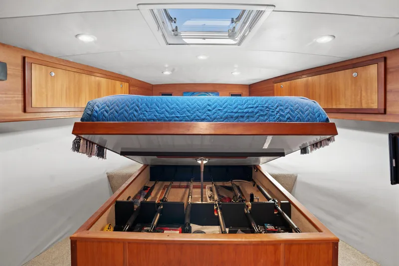 Slide: The Image of 2007 Custom Carolina Layton Express cabin with storage under a blue quilted bed. - 29