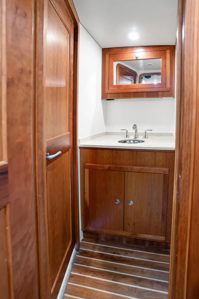 Slide: The Image of 2007 Custom Carolina Layton Express yacht bathroom with wooden cabinetry and modern sink. - 33