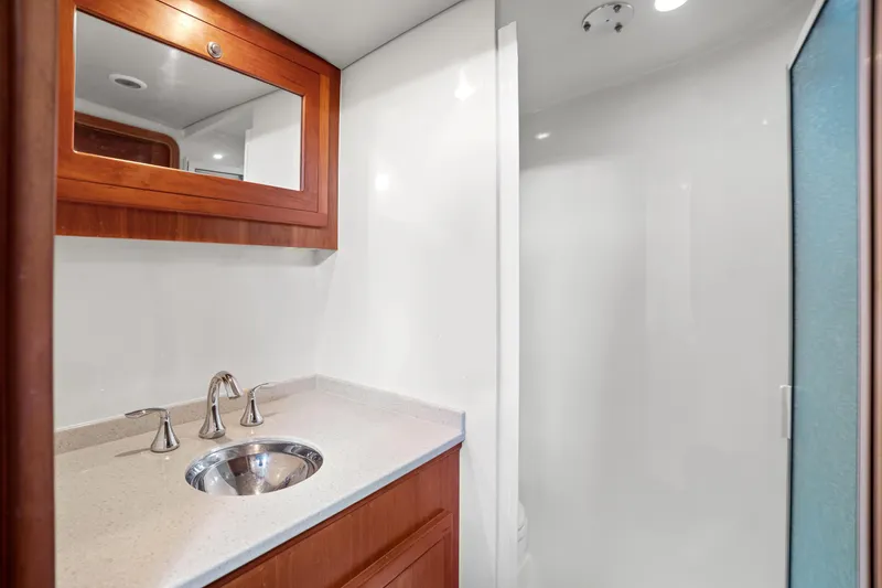 Slide: The Image of Luxurious 2007 Custom Carolina Layton Express bathroom with modern sink and wooden cabinetry. - 34