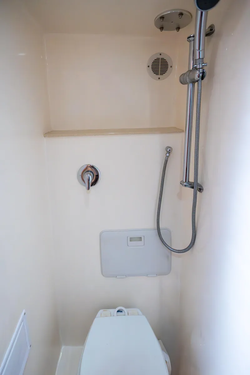 Slide: The Image of Compact bathroom in 2007 Custom Carolina Layton Express boat with shower and toilet. - 35