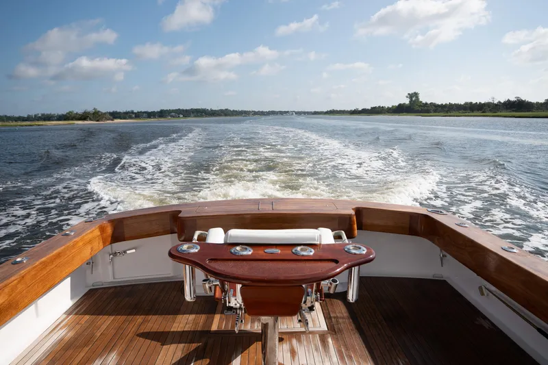 Slide: The Image of 2007 Custom Carolina Layton Express boat cruising on a sunny day, wooden deck and calm waters. - 38