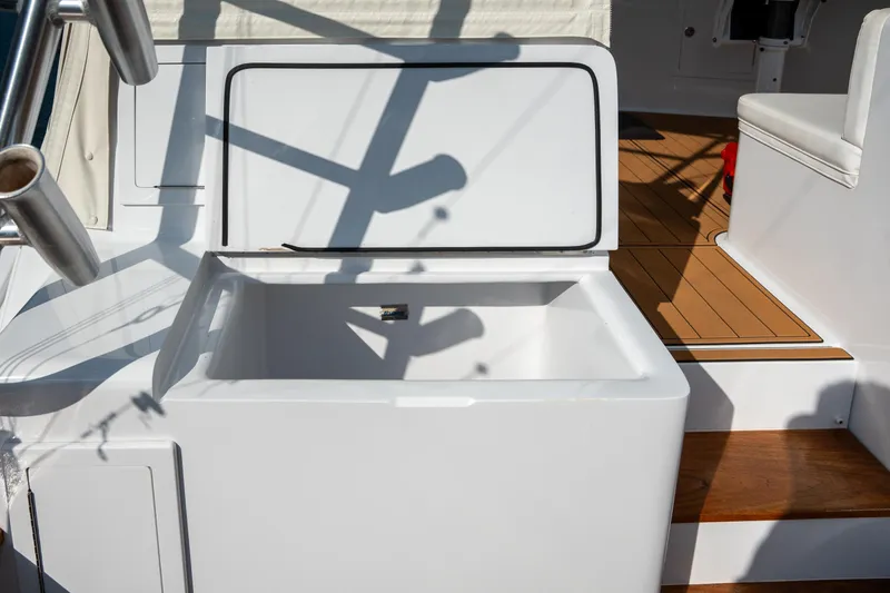 Slide: The Image of 2007 Custom Carolina Layton Express boat with open storage compartment and teak flooring. - 40