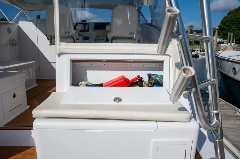 Slide: The Image of 2007 Custom Carolina Layton Express boat interior with storage compartment and fishing gear. - 43