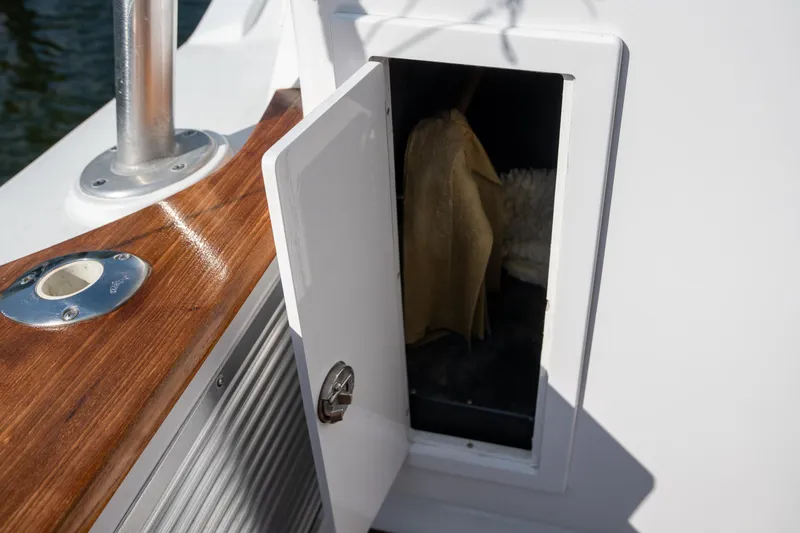 Slide: The Image of Open storage compartment on 2007 Custom Carolina Layton Express boat with wooden trim. - 44