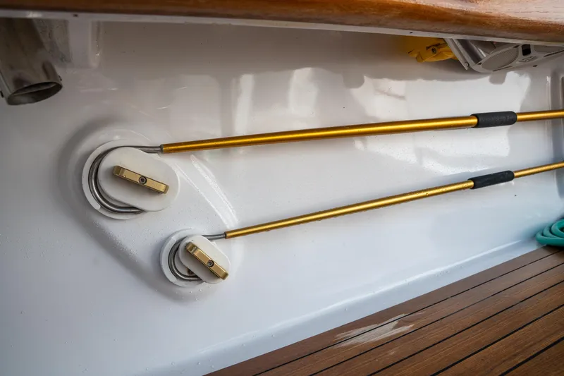 Slide: The Image of 2007 Custom Carolina Layton Express boat interior with gold rods and wooden deck. - 46