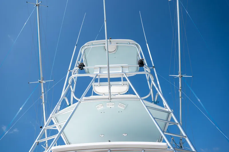 Slide: The Image of 2007 Custom Carolina Layton Express boat tower against clear blue sky. - 49