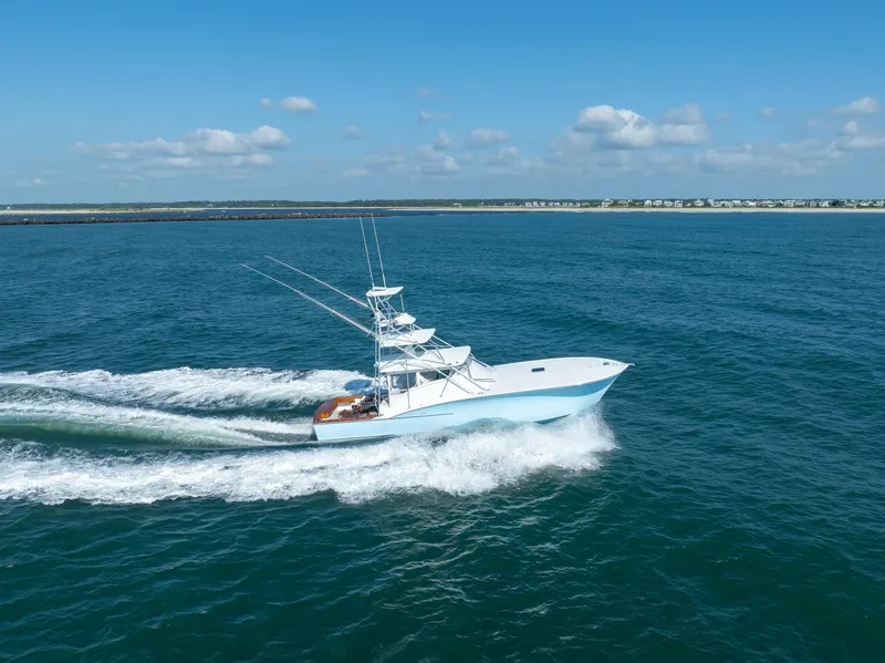 Slide: The Image of 2007 Custom Carolina Layton Express boat cruising on open water under a clear blue sky. - 5