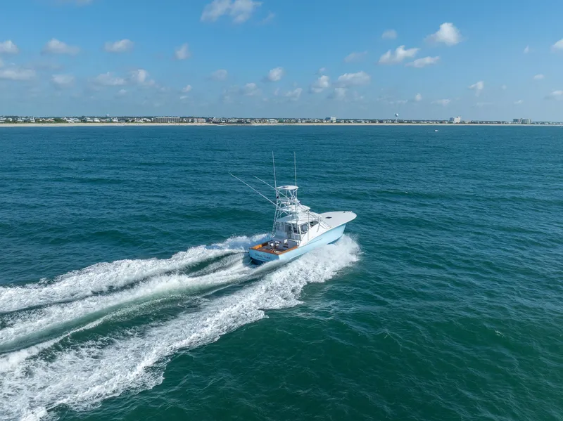 Slide: The Image of 2007 Custom Carolina Layton Express cruising on open ocean under clear blue sky. - 6