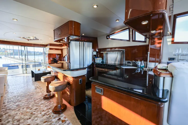 Slide: The Image of Luxurious 2006 Marquis 65 yacht interior with modern kitchen and elegant seating area. - 10