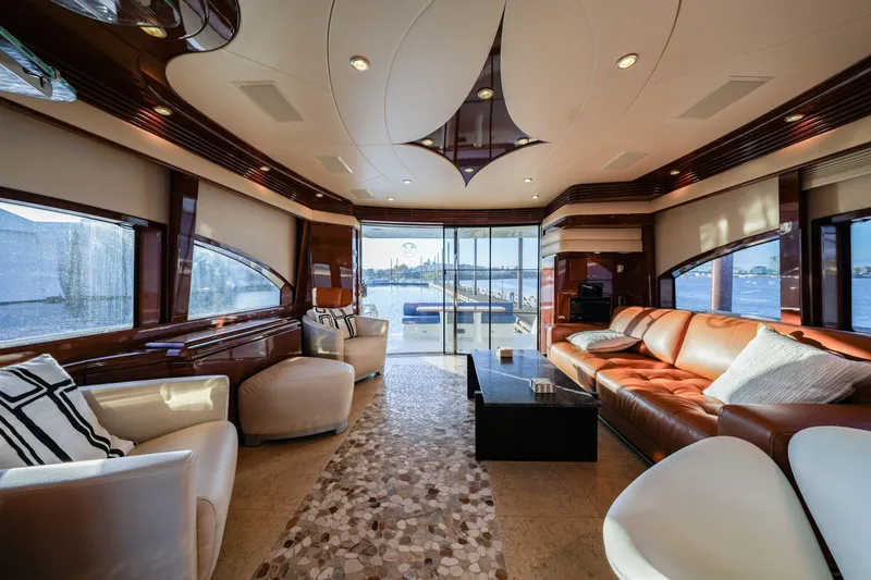 Slide: The Image of Luxurious interior of a 2006 Marquis 65 yacht with elegant seating and panoramic windows. - 11