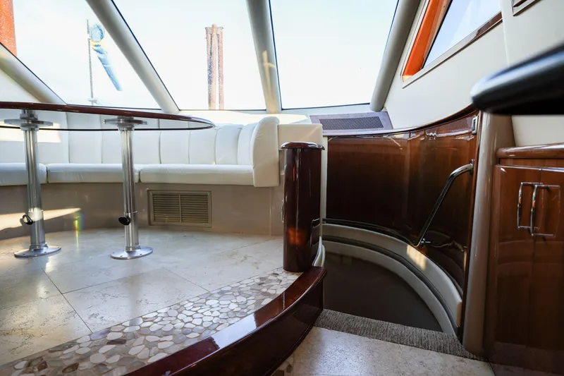 Slide: The Image of Luxurious interior of a 2006 Marquis 65 yacht with elegant seating and polished wood finishes. - 14