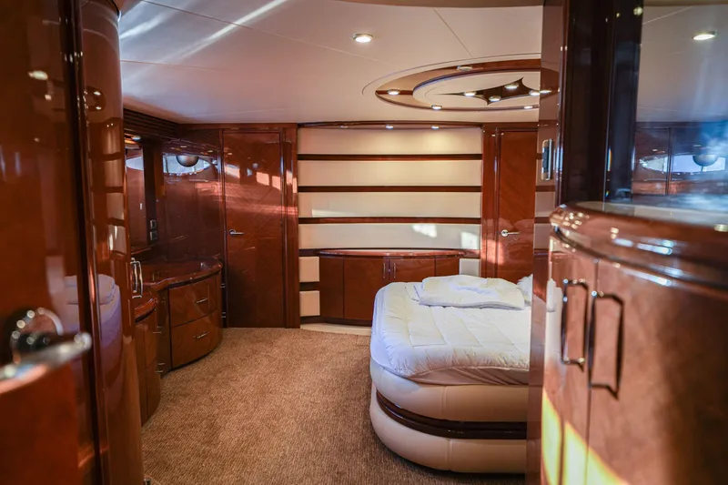 Slide: The Image of Luxurious 2006 Marquis 65 yacht interior with elegant wood finishes and cozy bedroom. - 16