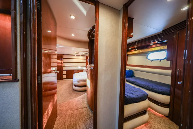 Slide: The Image of Luxurious interior of a 2006 Marquis 65 yacht with elegant wood finishes and cozy sleeping quarters. - 17