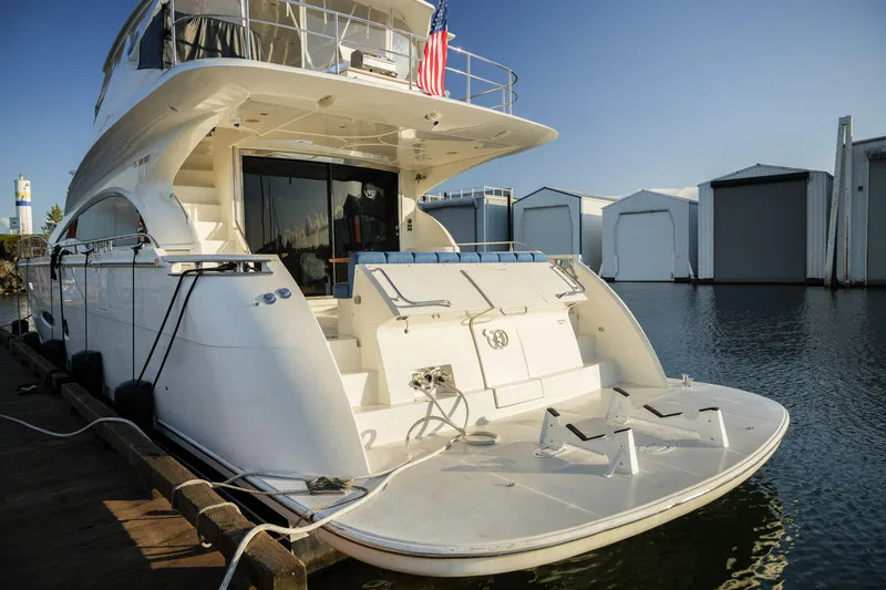 Slide: The Image of Luxury 2006 Marquis 65 yacht docked at marina, rear view with clear sky. - 2