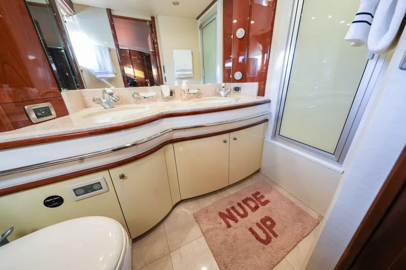 Slide: The Image of Luxurious 2006 Marquis 65 yacht bathroom with modern fixtures and playful "Nude Up" mat. - 20