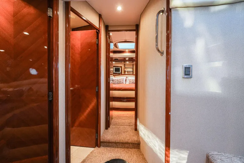 Slide: The Image of Luxurious interior hallway of a 2006 Marquis 65 yacht with wood finishes and modern lighting. - 23
