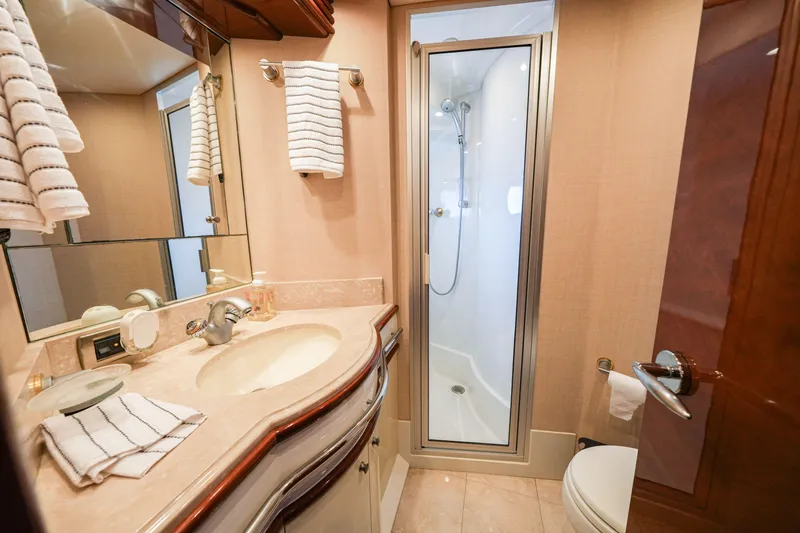Slide: The Image of Luxurious bathroom in 2006 Marquis 65 yacht with shower, sink, and elegant fixtures. - 28