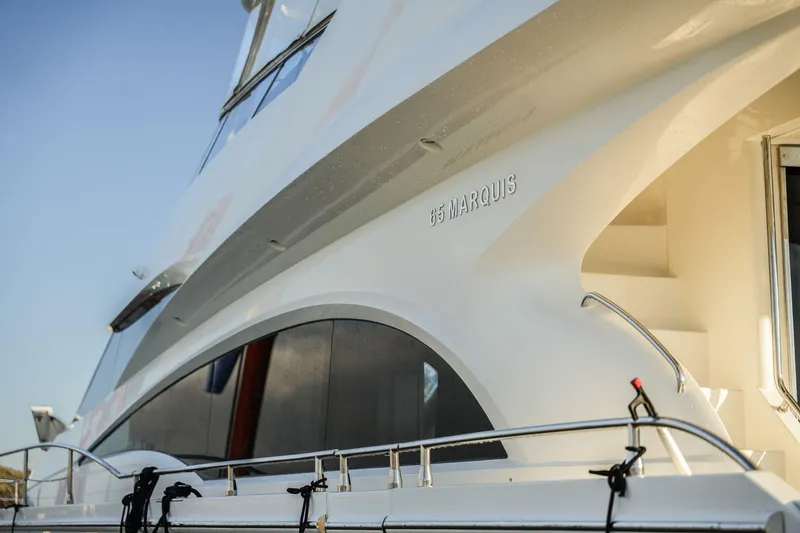 Slide: The Image of Luxury 2006 Marquis 65 yacht exterior with sleek design and elegant curves. - 3