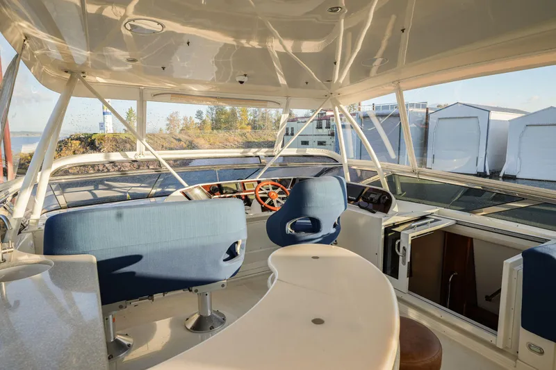 Slide: The Image of Interior view of 2006 Marquis 65 yacht helm with blue seating and panoramic windows. - 33