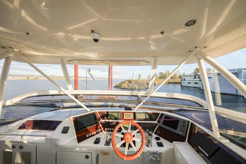 Slide: The Image of Interior view of 2006 Marquis 65 yacht helm with navigation equipment and scenic waterway. - 35
