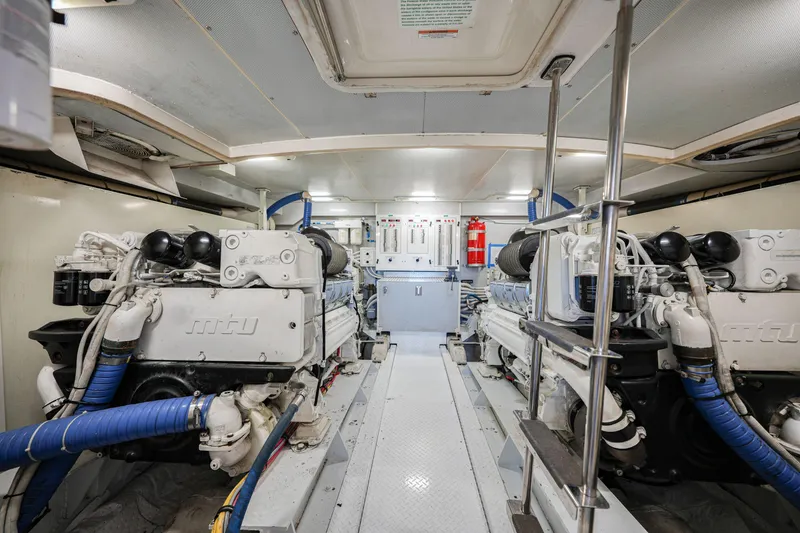 Slide: The Image of Engine room of a 2006 Marquis 65 yacht, featuring dual MTU engines. - 36