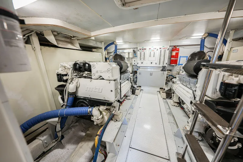 Slide: The Image of Engine room of a 2006 Marquis 65 yacht, featuring MTU engines and control panels. - 37