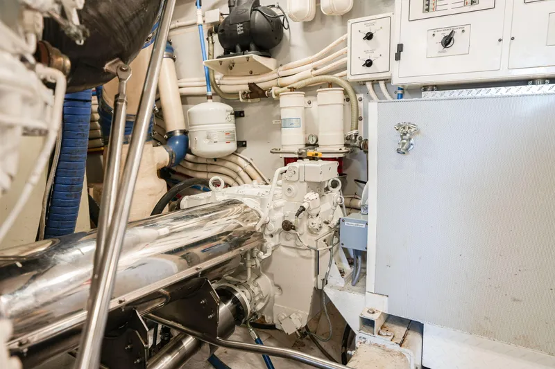 Slide: The Image of Engine room of a 2006 Marquis 65 yacht, featuring complex machinery and control panels. - 38