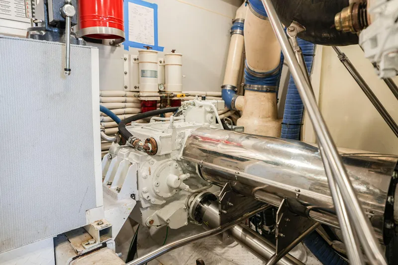 Slide: The Image of Engine room of a 2006 Marquis 65 yacht, featuring mechanical components and piping. - 39