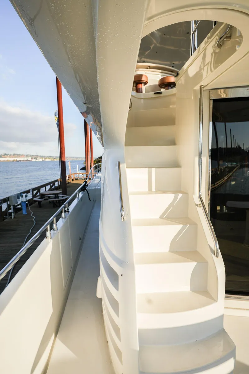 Slide: The Image of Staircase on a 2006 Marquis 65 yacht, docked by the water. - 6