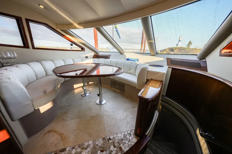Slide: The Image of Luxurious interior of a 2006 Marquis 65 yacht with elegant seating and panoramic windows. - 9