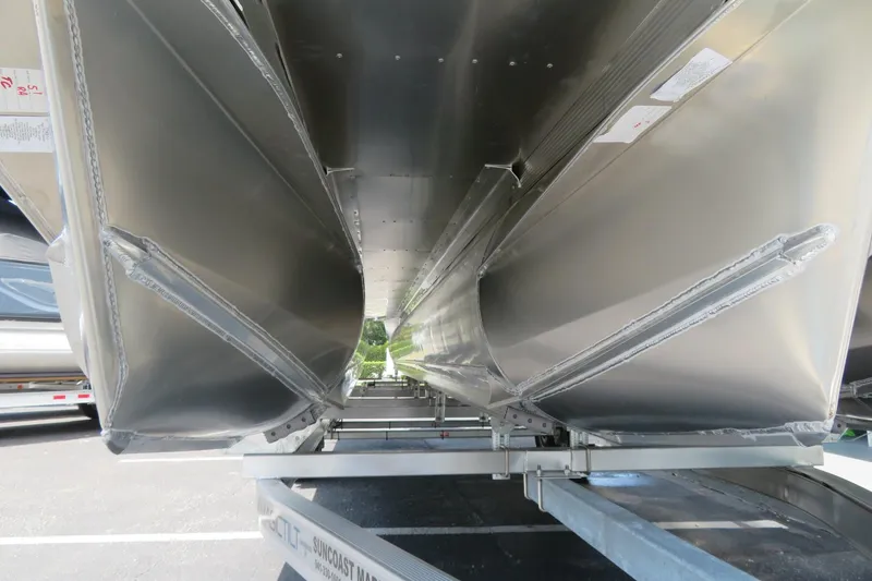 Slide: The Image of Underneath view of 2026 Avalon Excalibur LTD Elite Windshield boat on trailer. - 87