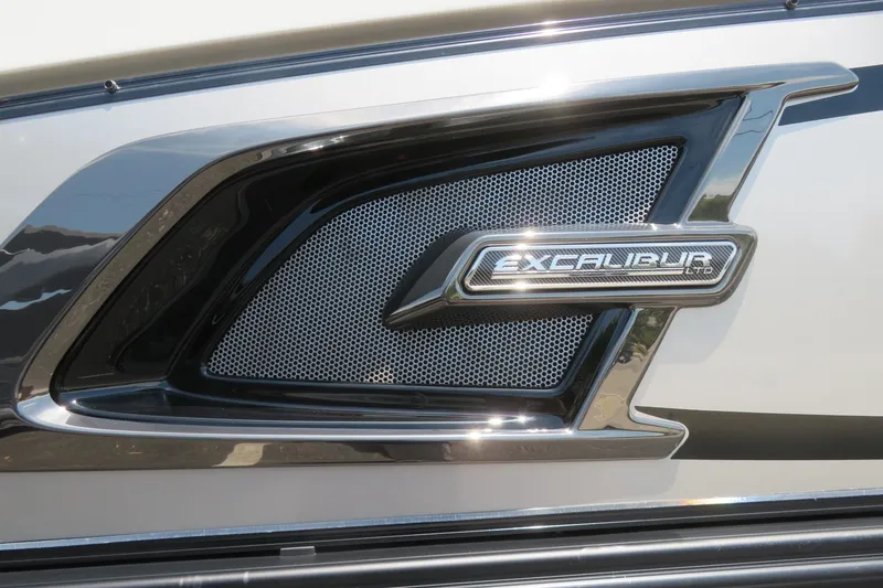 Slide: The Image of 2026 Avalon Excalibur LTD 25’ Tritoon on water, city skyline in background. - 2