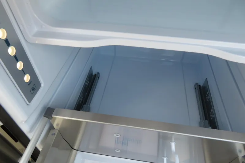 Slide: The Image of Under-seat storage in 2026 Avalon Excalibur LTD Elite Windshield boat, featuring quilted upholstery. - 39