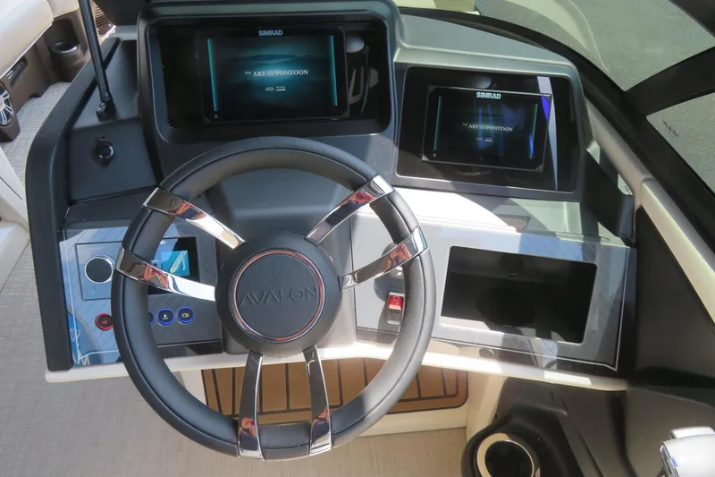 Slide: The Image of Interior of 2026 Avalon Excalibur LTD Elite Windshield boat with modern kitchenette. - 49