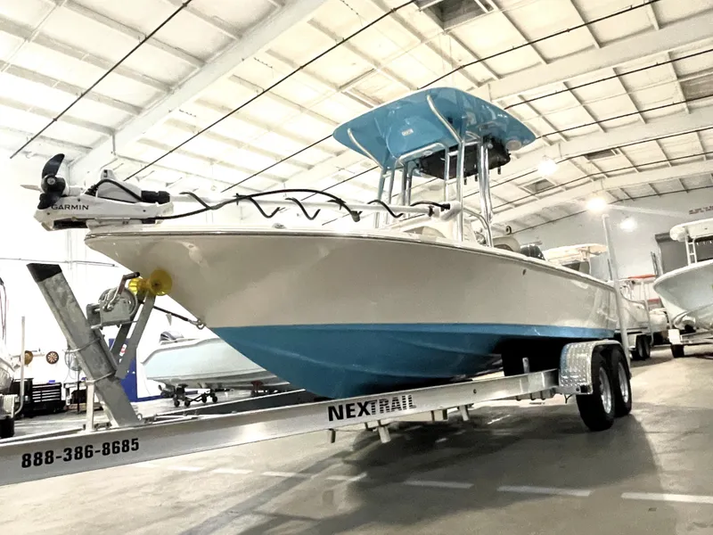 The Image of 2025 Key West 210 Bay Reef boat on trailer in indoor showroom. - 1