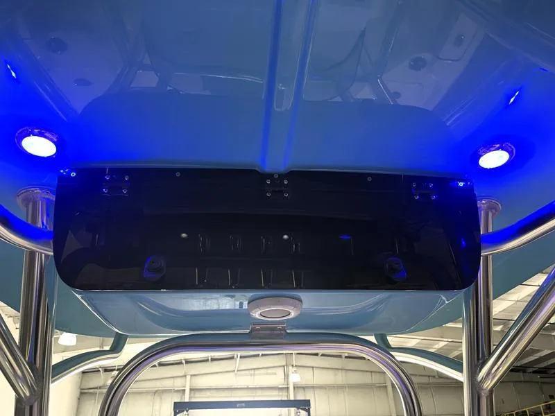 Slide: The Image of 2025 Key West 210 Bay Reef boat with blue LED lights and stainless steel frame. - 11