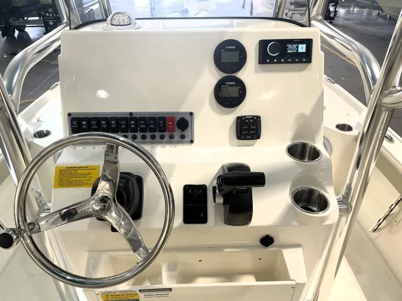 Slide: The Image of 2025 Key West 210 Bay Reef boat console with steering wheel and controls. - 12