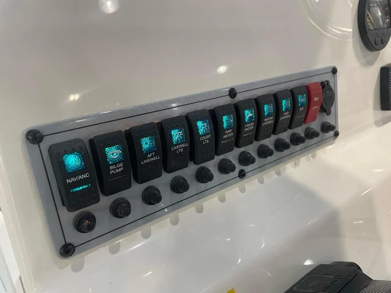 Slide: The Image of Control panel of 2025 Key West 210 Bay Reef boat with illuminated switches. - 15