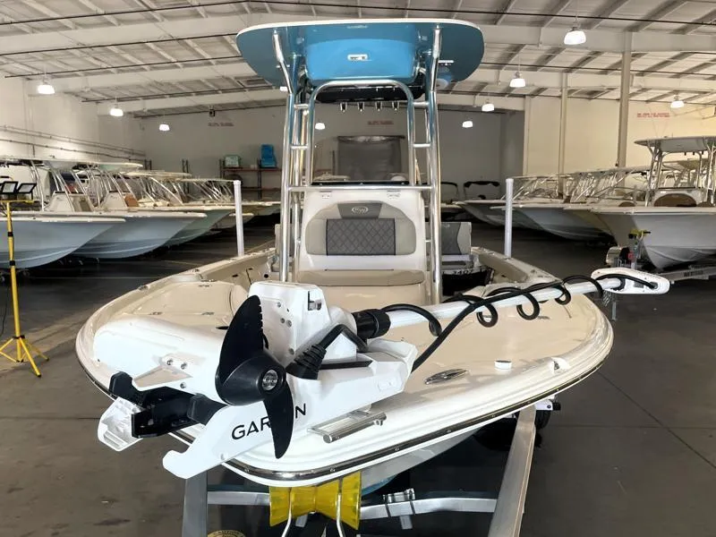 Slide: The Image of 2025 Key West 210 Bay Reef boat in showroom, featuring Garmin equipment. - 16