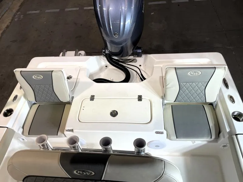 Slide: The Image of 2025 Key West 210 Bay Reef boat interior with seating and motor, showcasing modern design. - 19