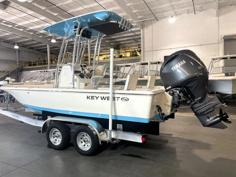 Slide: The Image of 2025 Key West 210 Bay Reef boat with Yamaha engine on trailer in warehouse. - 3