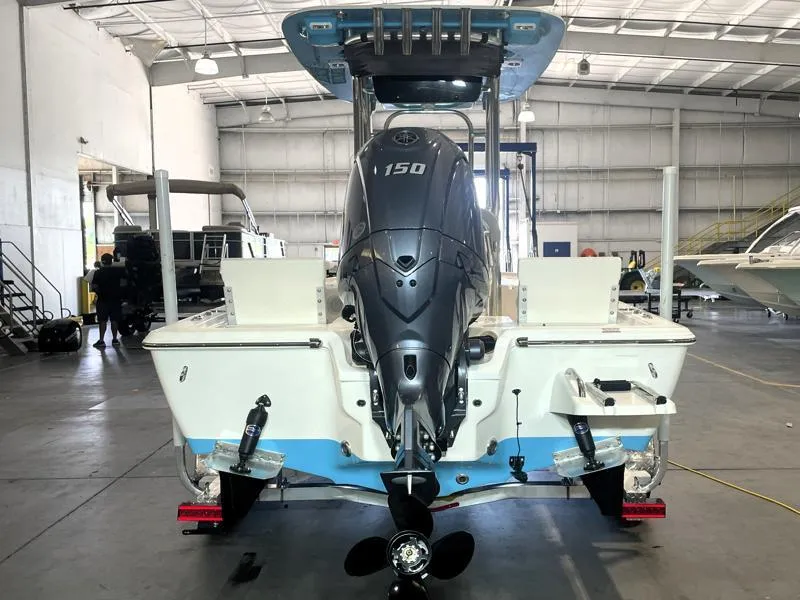 Slide: The Image of 2025 Key West 210 Bay Reef boat with 150 HP engine in a warehouse. - 6