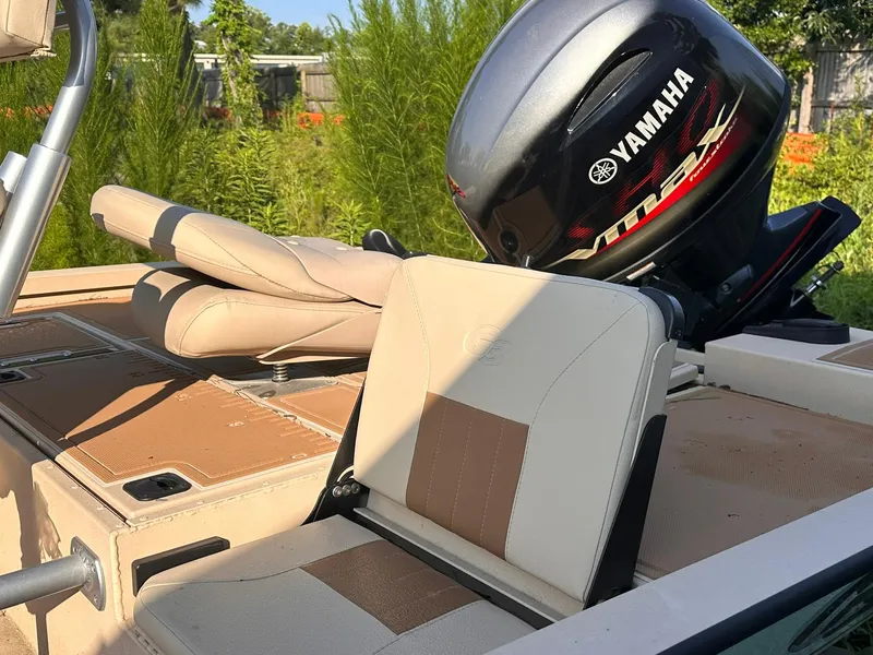 Slide: The Image of 2024 G3 Bay 20 GX boat with Yamaha VMAX engine, beige seating, and lush greenery background. - 11