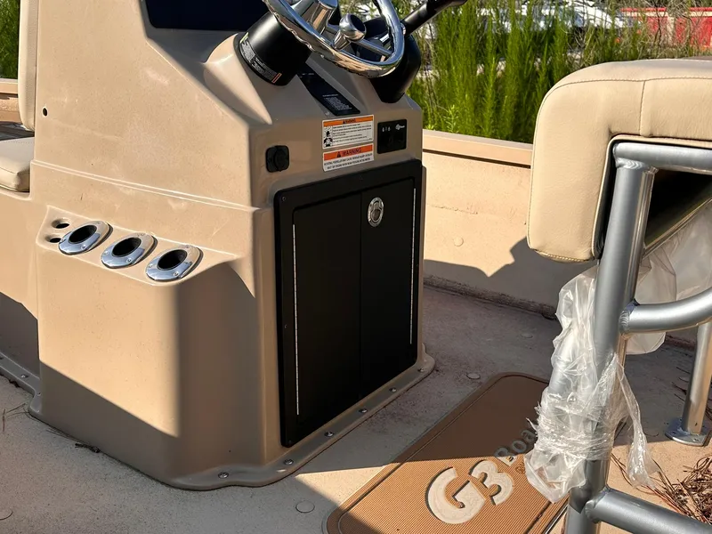 Slide: The Image of 2024 G3 Bay 20 GX boat interior with steering console and seating area. - 12