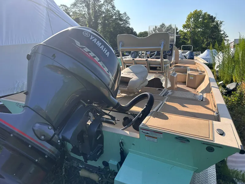 Slide: The Image of 2024 G3 Bay 20 GX boat with Yamaha outboard motor, parked outdoors. - 16